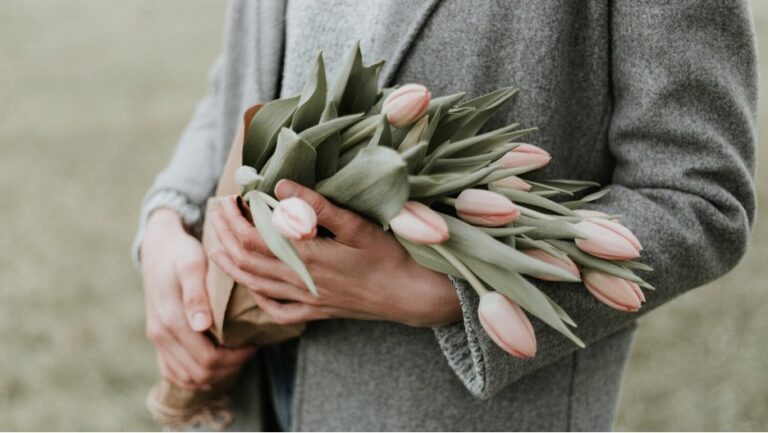 A person holding a bouquet of flowers for Mother's Day