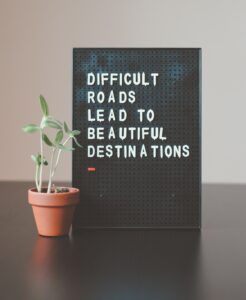 Sign reading "Difficult roads lead to beautiful destinations"