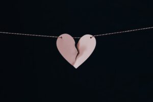 Black background with pink broken heart 