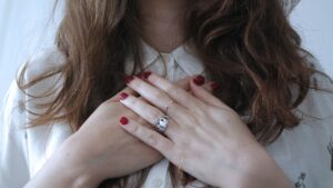 Girl with her hands over her chest as to say she is showing compassion toward herself