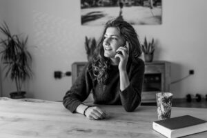 Black and white photo of woman providing phone coaching