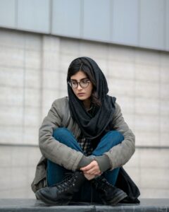 girl sad sitting outside of building