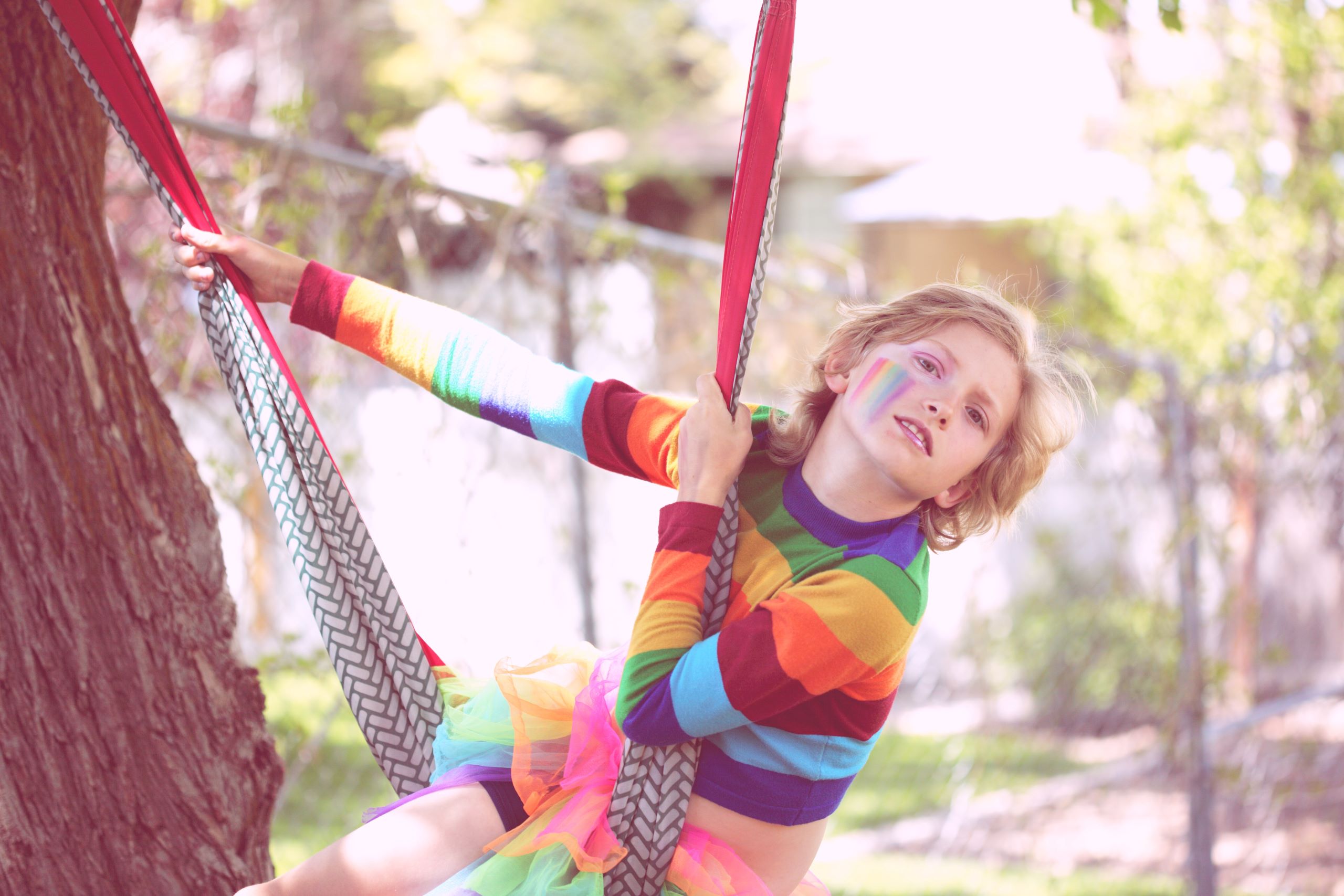 transgender child on a swing rainbow