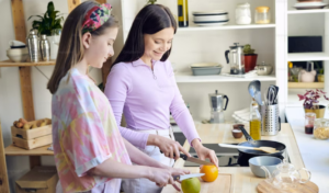 Mother and child cutting fruit applying dialectics