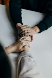close up of two people holding hands