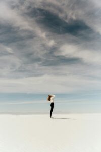 woman standing alone on beach 