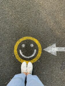 An arrow on the pavement directing you to stand on a "happy face"