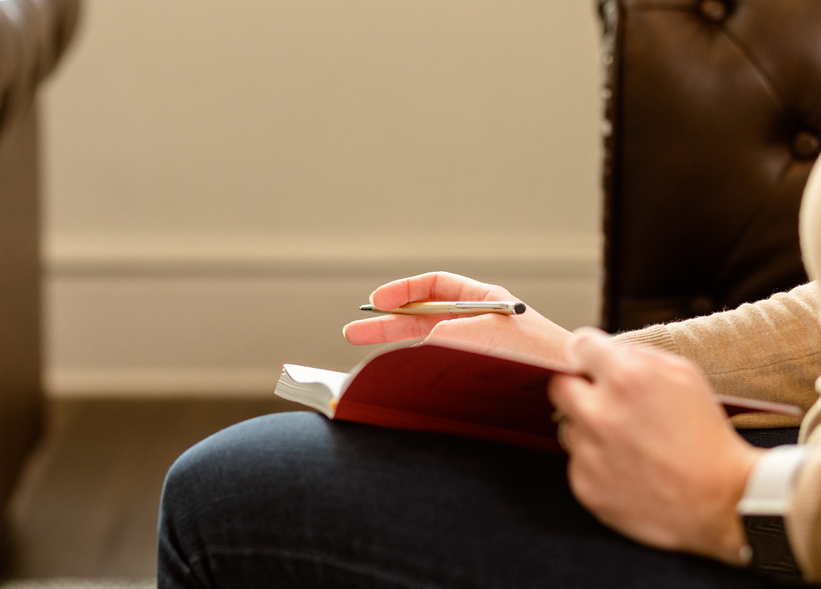 Cincinnati DBT Client hands poised to write in a notebook to apply for the Nunc Coepi DBT Scholarship