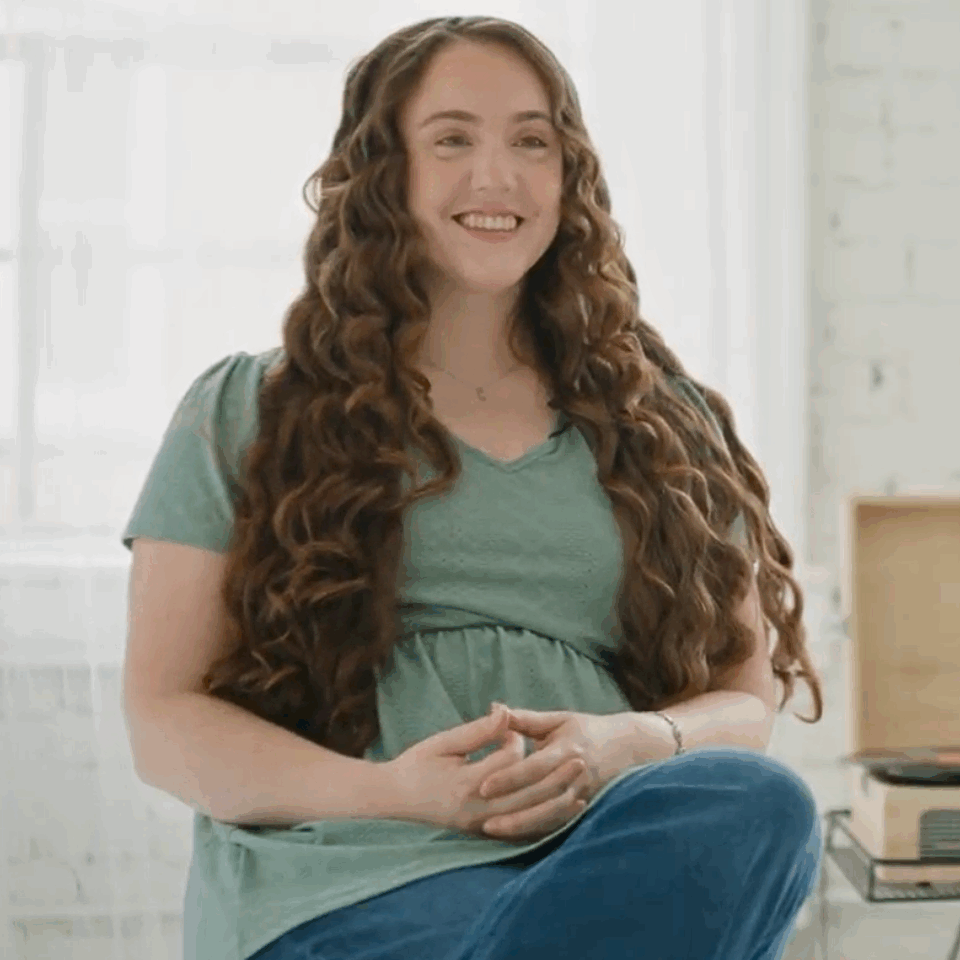 Cincinnati DBT Psychologist Heather Smith smiles at the camera with hands in her lap, discussing her passion for working with suicidal clients and those with trauma